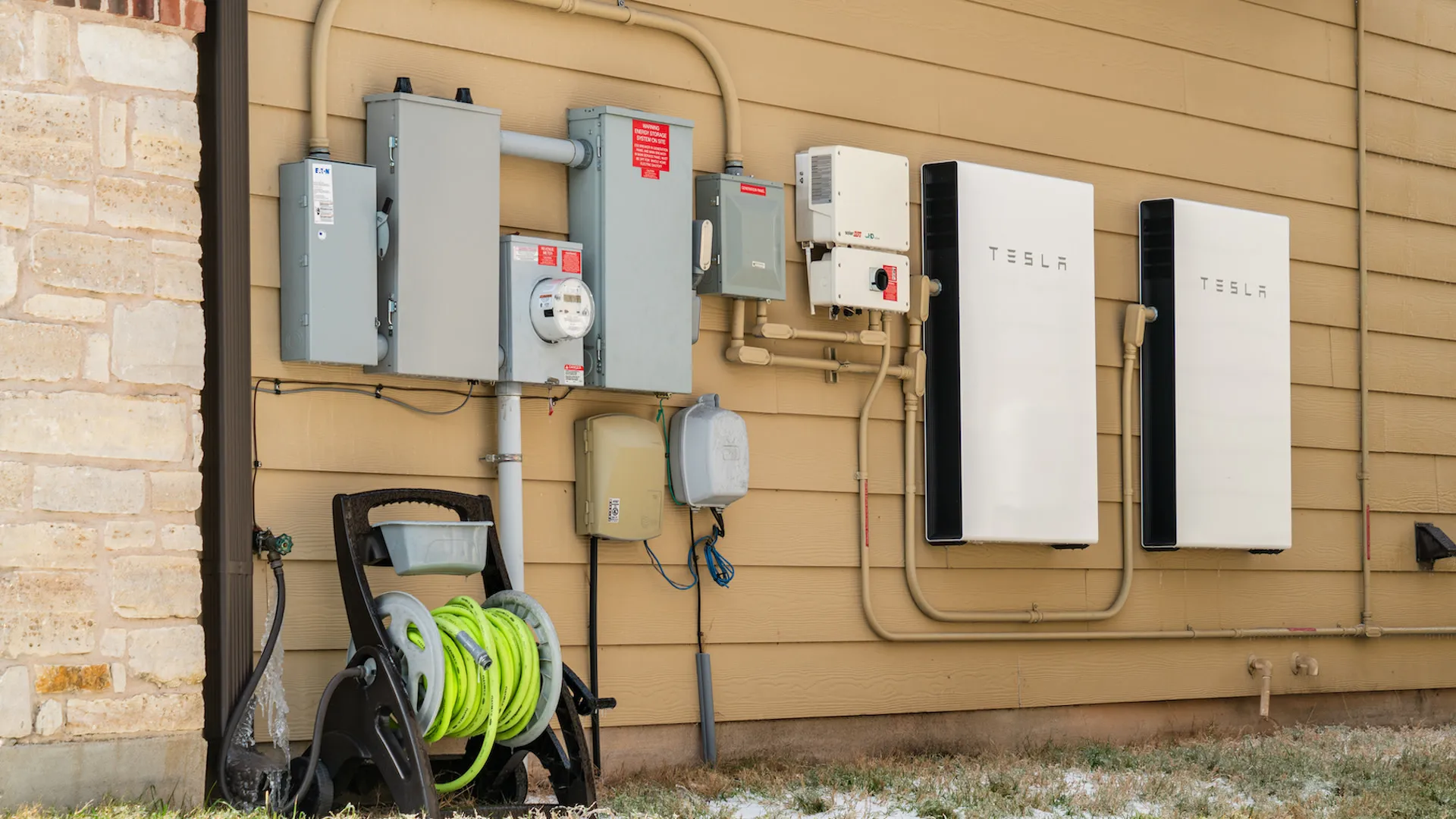 Two Tesla Powerwalls installed on a home exterior